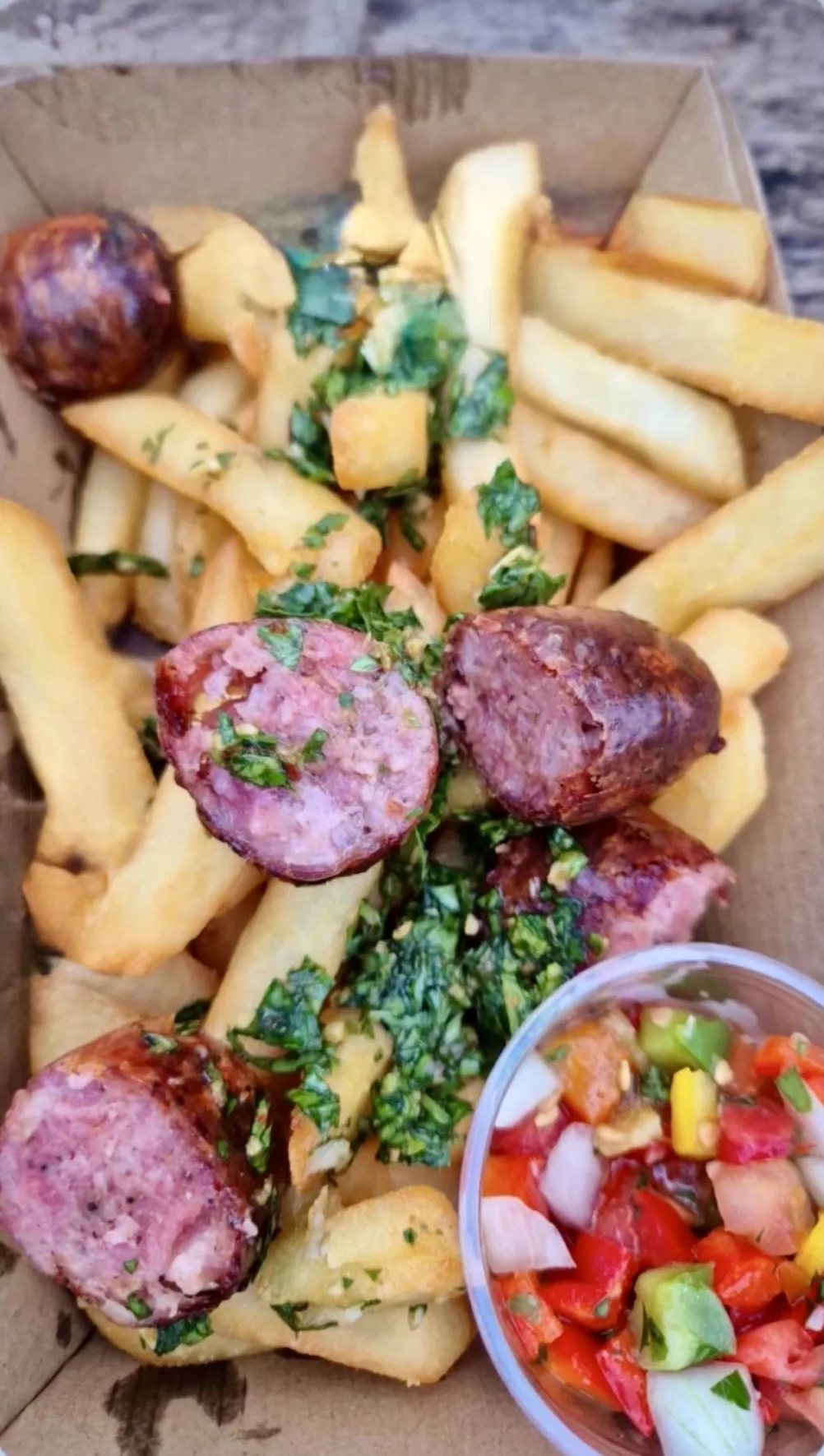 La Mila loaded chips with chorizo, chimichurri and salsa criolla